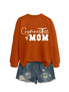 Detail of orange Gymnastics MOM sweatshirt with ribbed cuffs and blue distressed denim shorts