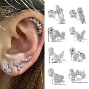 Macro detail of geometric zircon cartilage studs with double-head screw ball backings