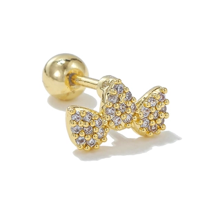 Close-up of golden bow stud earring with clear zircon inlay and secure screw back ball