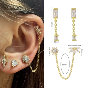 Detailed size view of gold tassel ear studs with star and heart zircon details