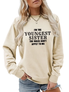 Detail of youngest sister slogan and ribbed texture on beige crewneck sweatshirt
