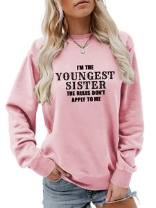 Close-up of pink sweatshirt with I'm the Youngest Sister slogan and black lettering