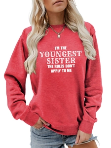 Detail of red crewneck sweatshirt with white I'M THE YOUNGEST SISTER slogan print