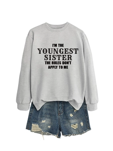 Detail of light grey crewneck sweatshirt with 'Youngest Sister' slogan print on front