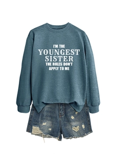 Flat lay of gray-blue sweatshirt with white lettering paired with distressed denim shorts