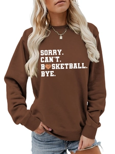 Close-up of the Sorry Can't Basketball Bye slogan and heart icon on a brown sweatshirt