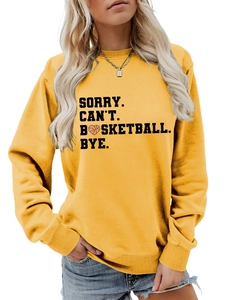 Detail of yellow crewneck sweatshirt featuring black basketball slogan and heart design