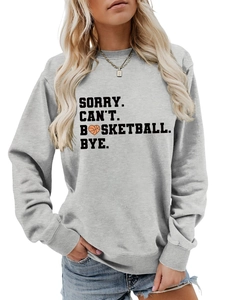 Close-up of grey sweatshirt with Sorry Can't Basketball Bye print and heart ball