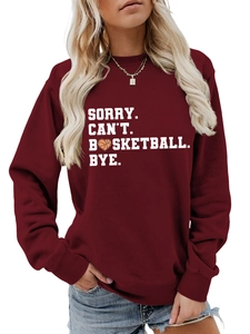 Detail of burgundy sweatshirt featuring Sorry Can't Basketball Bye text with heart basketball