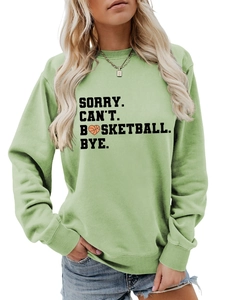 Detail of light green sweatshirt fabric with black basketball heart print and slogans