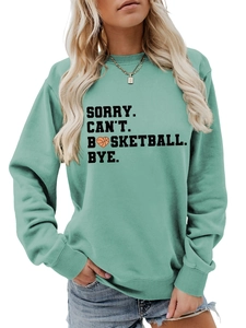 Detail of mint green sweatshirt featuring bold Sorry Can't Basketball Bye text print
