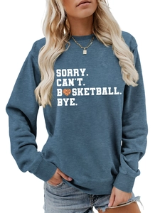Close-up of Sorry Can't Basketball Bye slogan print on blue crewneck sweatshirt
