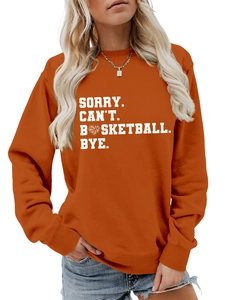 Detail of orange crewneck sweatshirt featuring white sorry can't basketball bye slogan