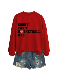 Detail of red sweatshirt with 'SORRY CAN'T BASKETBALL BYE' slogan and frayed denim shorts
