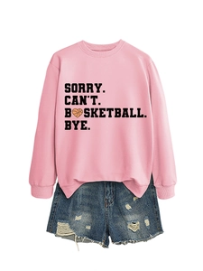 Flat lay of pink sweatshirt with 'SORRY CAN'T BASKETBALL BYE' text and denim shorts