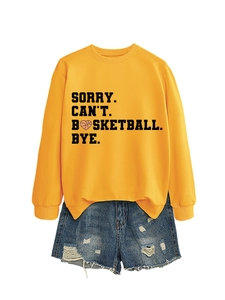 Flat lay of yellow 'Sorry Can't Basketball Bye' sweatshirt with denim shorts