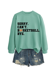 Detail of mint green sweatshirt with SORRY CAN'T BASKETBALL BYE print and denim shorts