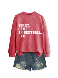 Flat lay of red basketball sweatshirt and distressed denim shorts with graphic text