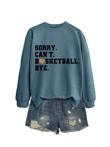 Detail of blue sweatshirt with 'SORRY CAN'T BASKETBALL BYE' text and denim shorts