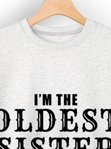 Detail of grey heather cotton sweatshirt showing I'M THE OLDEST SISTER printed text