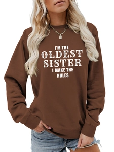 Detail of chocolate brown sweatshirt featuring vintage white I'm The Oldest Sister print