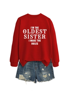 Close-up of red sweatshirt with I'M THE OLDEST SISTER print and distressed denim shorts