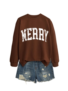 Detail of a brown crewneck sweatshirt featuring white MERRY lettering and blue denim shorts