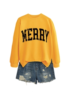 Detail of a bright yellow sweatshirt with black MERRY lettering and distressed denim shorts