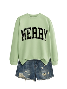 Detail of light green sweatshirt with black MERRY lettering and distressed denim shorts