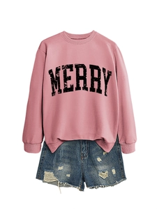 Close-up of pink crewneck sweatshirt with MERRY letter print and distressed denim shorts