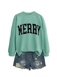 Detail of mint green sweatshirt with distressed black MERRY text and ripped denim shorts