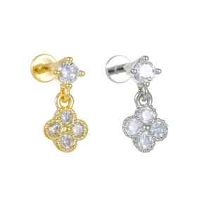 Detailed view of silver and gold four-leaf clover stud earrings with cubic zirconia stones