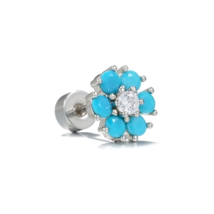 Detailed macro view of a silver flower stud earring with blue stones and zircon center