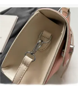 Detail view of silver metal clasp and texture on vintage matte crossbody bag