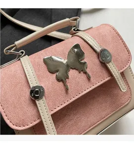 Close-up of pink textured fabric with silver butterfly clasp and rivet accents