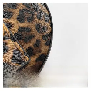 Close-up of leopard print embossed leather texture on large capacity shoulder bag
