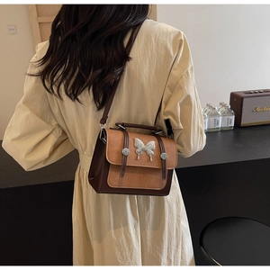 Vintage contrast color crossbody bag with matte texture and butterfly metal buckle