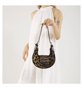 Detail of leopard print crescent bag featuring gold buckle and retro pattern texture