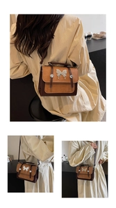 Detail of vintage patchwork crossbody bag with metallic butterfly buckle and matte texture