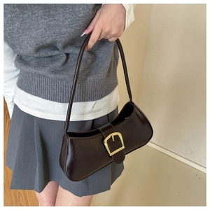 Retro dark brown underarm bag with gold buckle shown on model in college style outfit