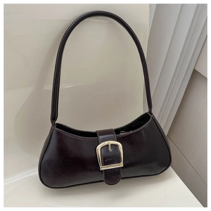 Close-up of sleek dark leather baguette bag with premium gold metal buckle detail