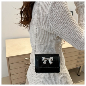 Chic black mini chain crossbody bag with silver metal bow accent for stylish women