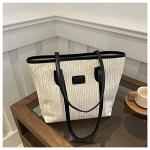 Straw tote bag in cream herringbone weave with black leather trim and top handles