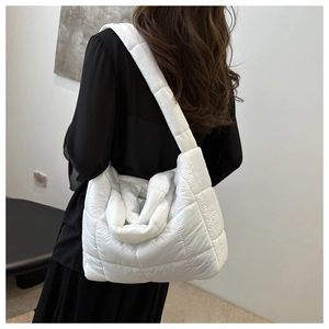 Détail du sac cabas matelassé blanc montrant les coutures carrées et la texture douce