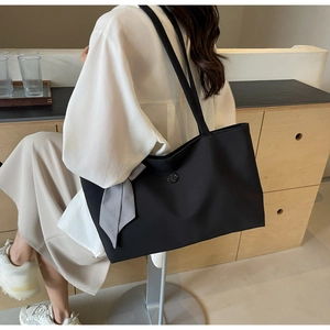 Chic black PU leather tote bag with stylish gingham bow detail and embossed logo emblem