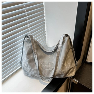 Detail view of silver grey tote bag with marble textured crinkle faux leather finish