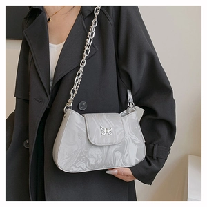 Detail of grey marble pattern handbag with butterfly buckle and silver chain strap