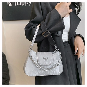 Detail of grey marble pattern patent leather shoulder bag with silver butterfly buckle