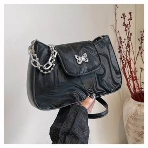 Women's marbled chain shoulder bag with butterfly buckle and silver sphere strap accents