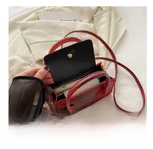 Internal view of red crocodile pattern handbag showing space for a mobile phone